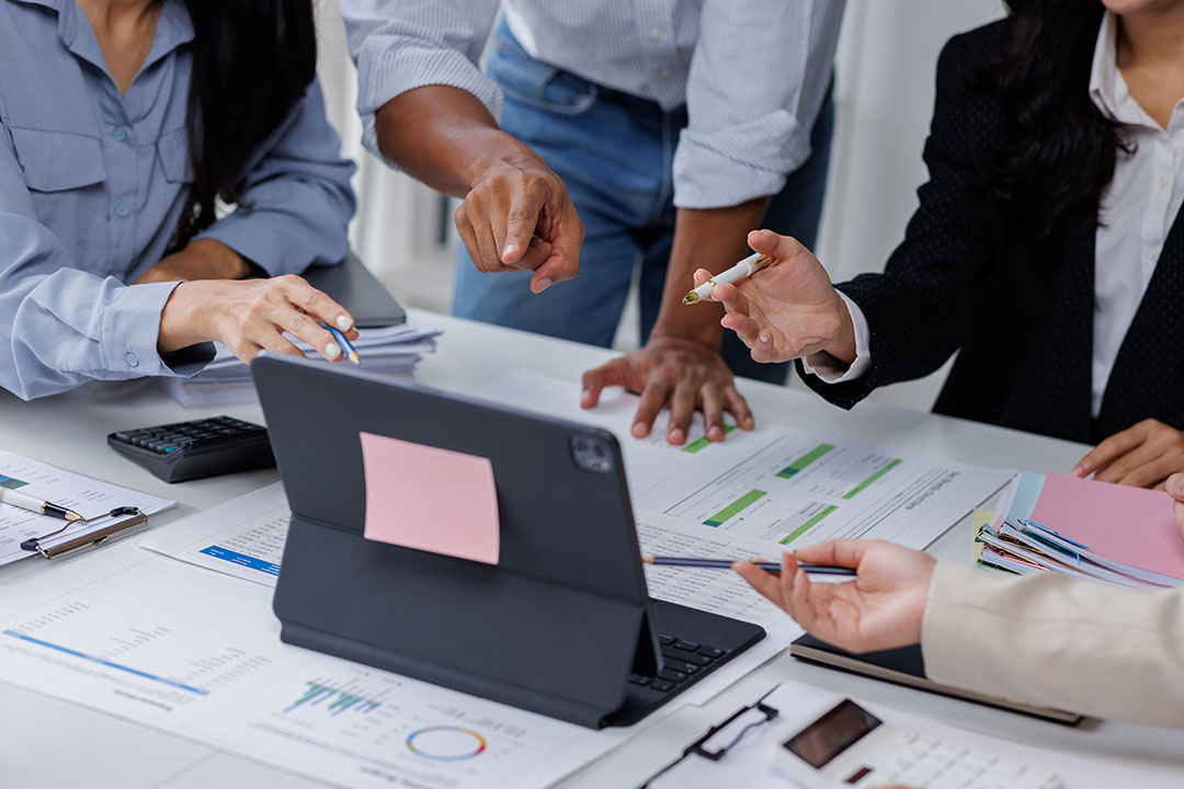 Supply chain managers reviewing data to evaluate supply chain management outsourcing partners